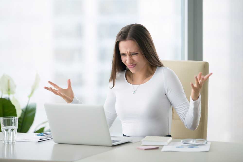 Young,businesswoman,at,modern,home,office,desk,with,laptop,impressed